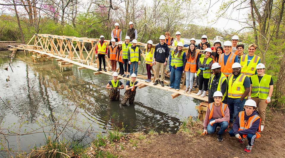 Timber, steel, and teamwork: Engineering students build and deconstruct 80-ft truss bridge over water