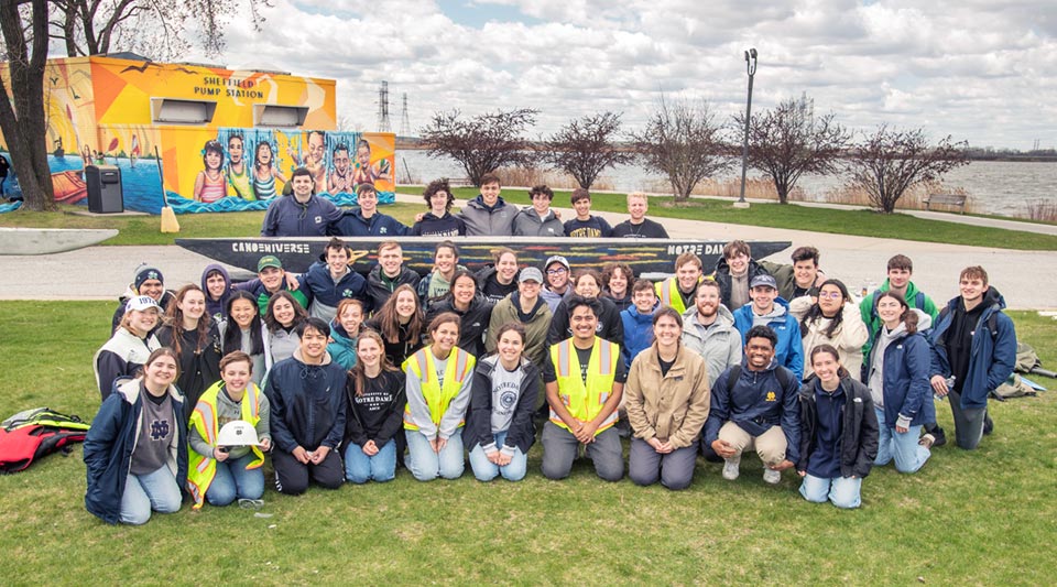 A group photo of the students who participated in the 2024 ASCE competitions pose in front of their concrete canoe.