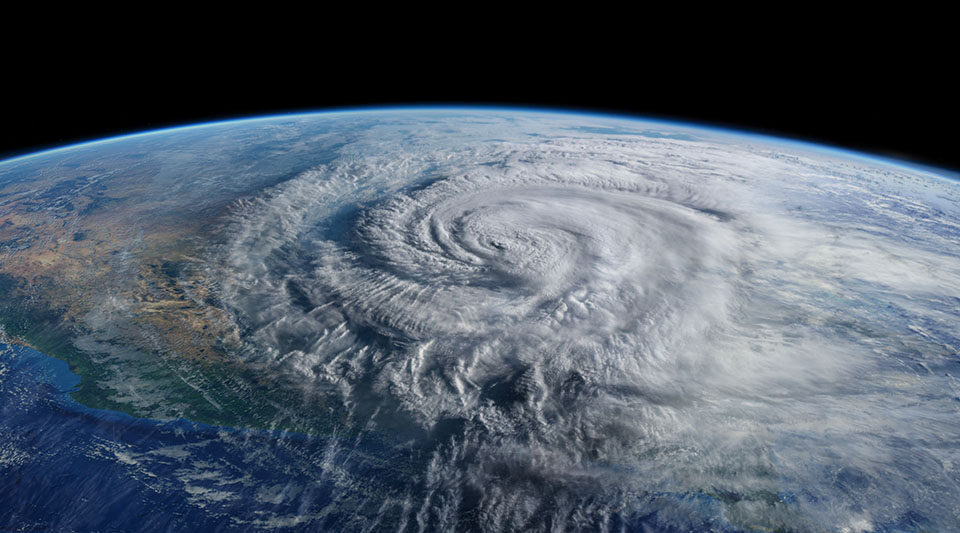 A composite rendering of a hurricane over ocean and land