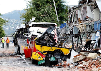 Natural disaster site showing damaged vehicles